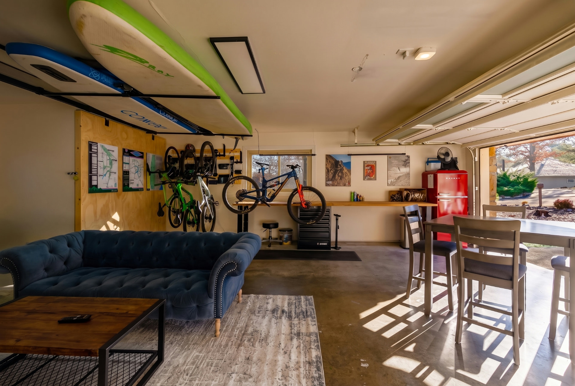 Adventure gear lounge with bikes, boards, and a red fridge
