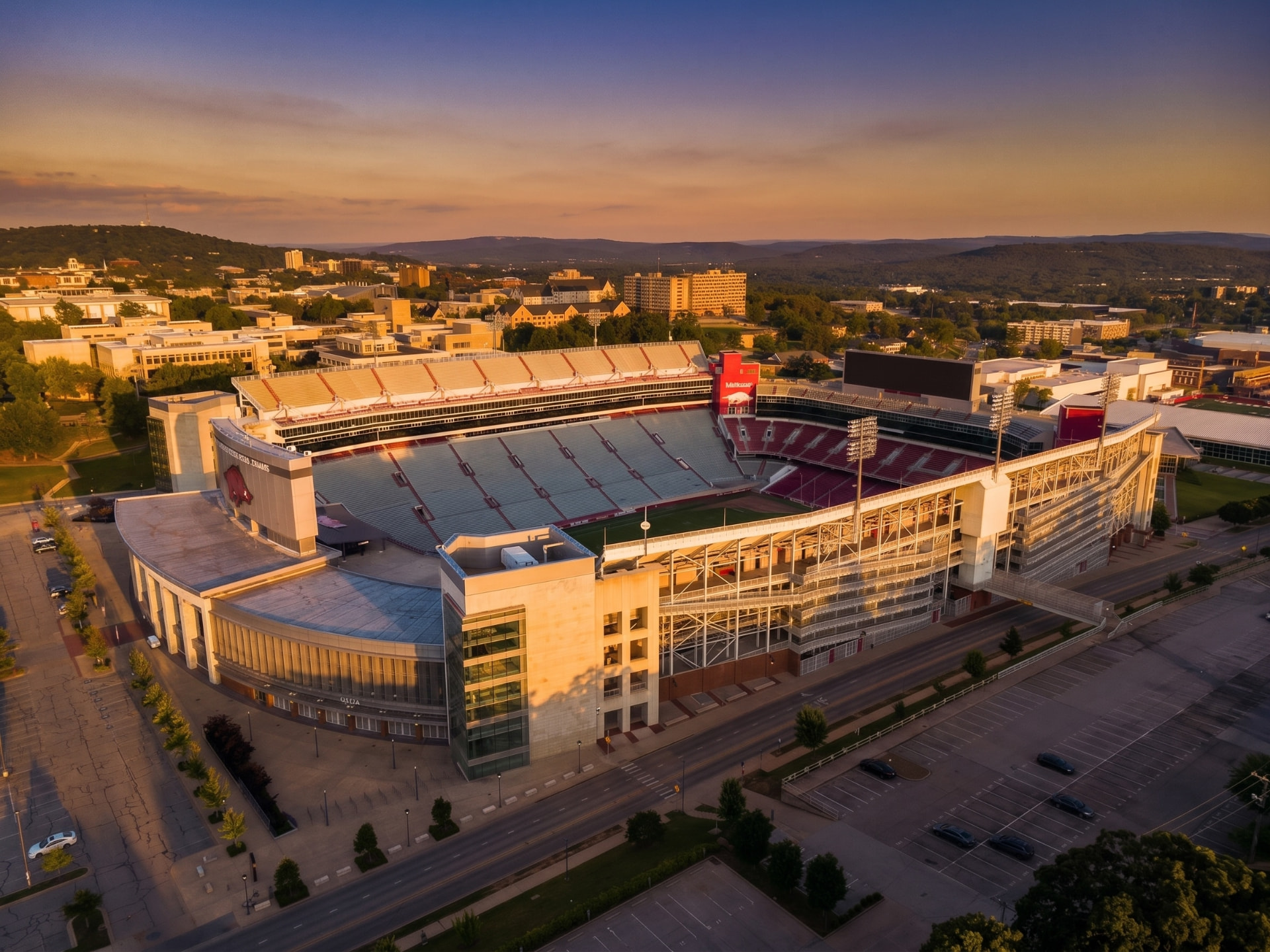 Sports stadium on a college campus bathed in golden sunset light