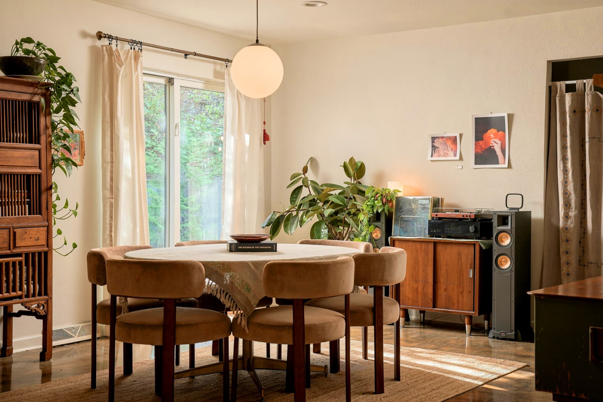 Dining room with round table and globe pendant light