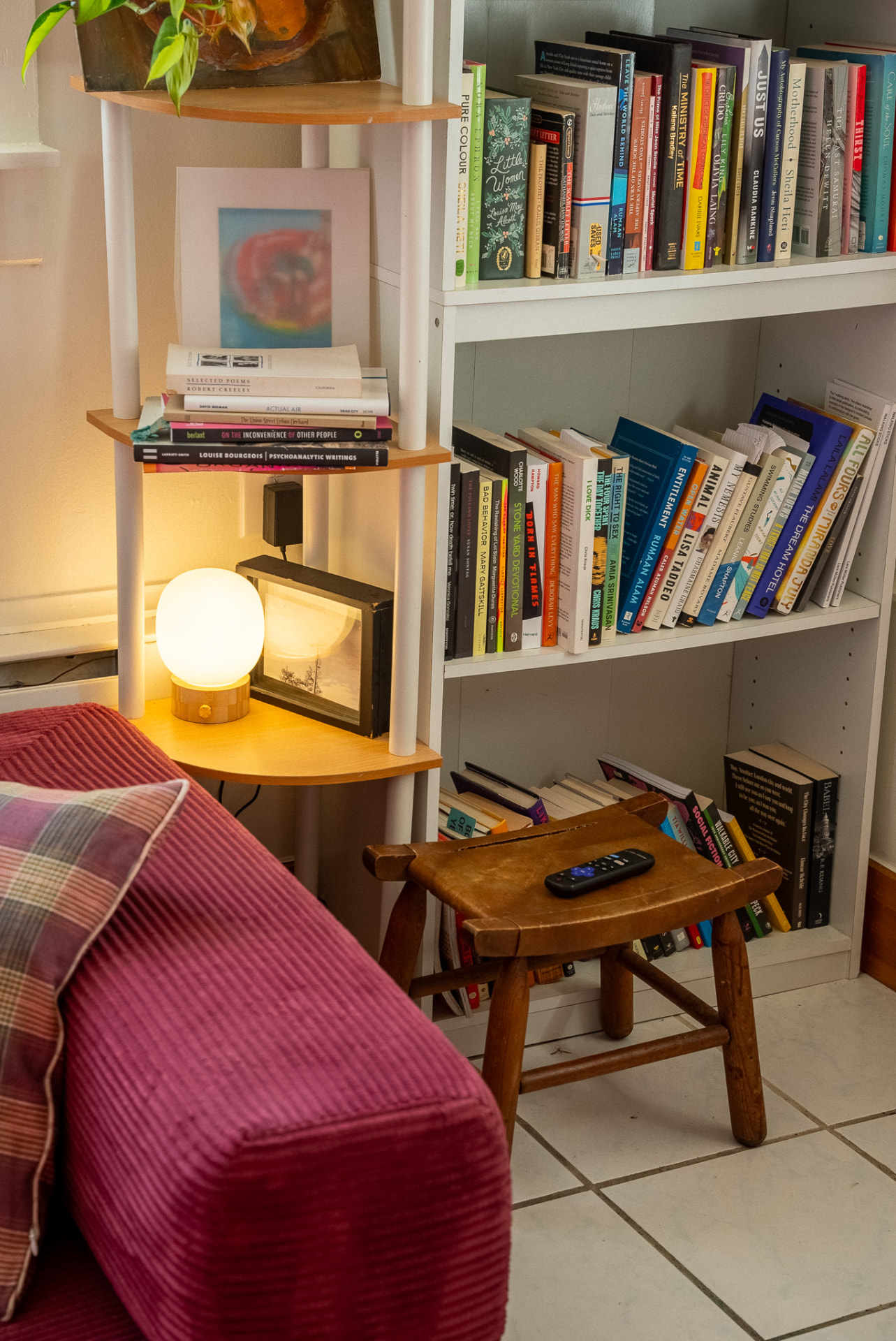 Reading nook with a glowing lamp and stacked books