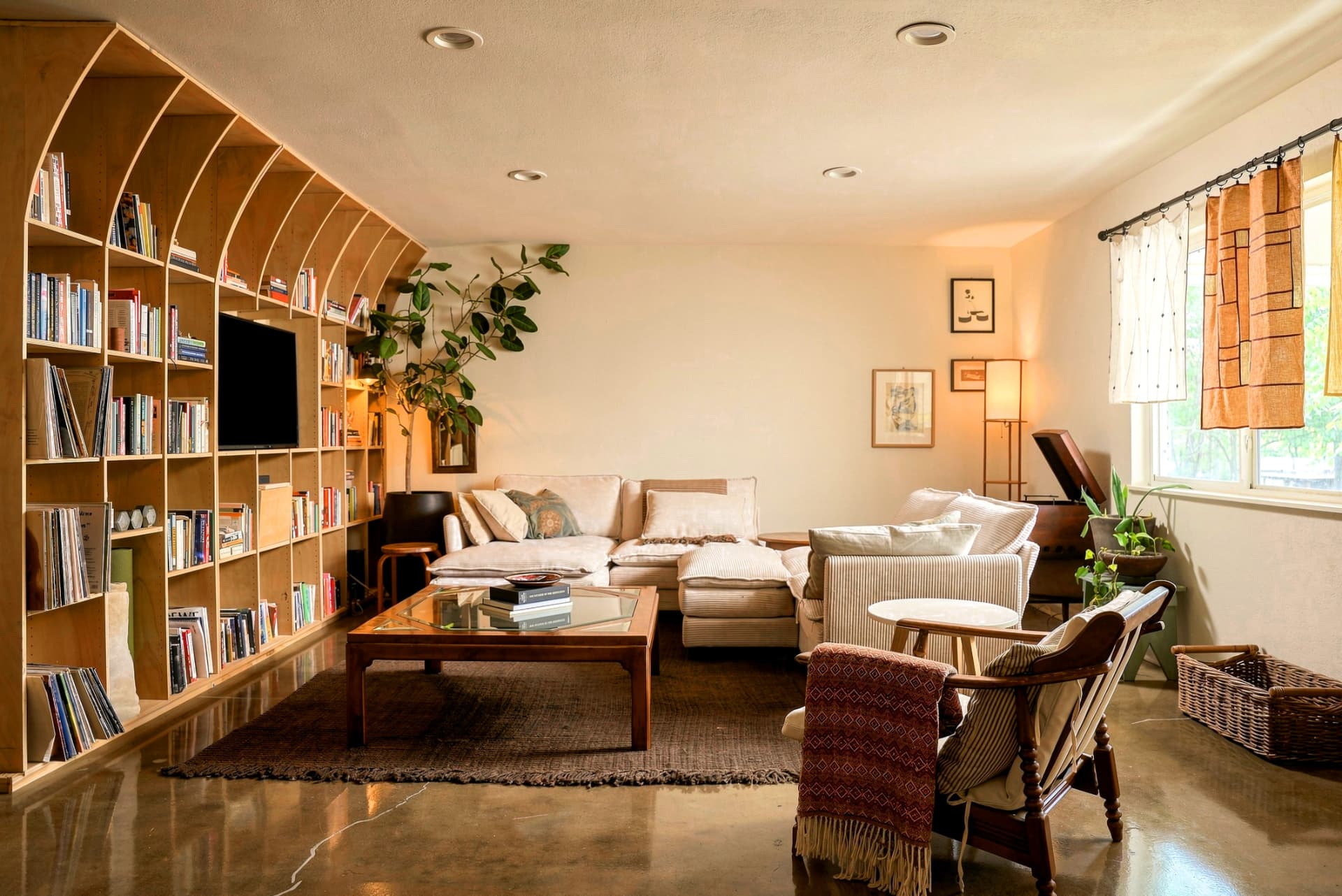 Warm living room with arched wooden bookshelves