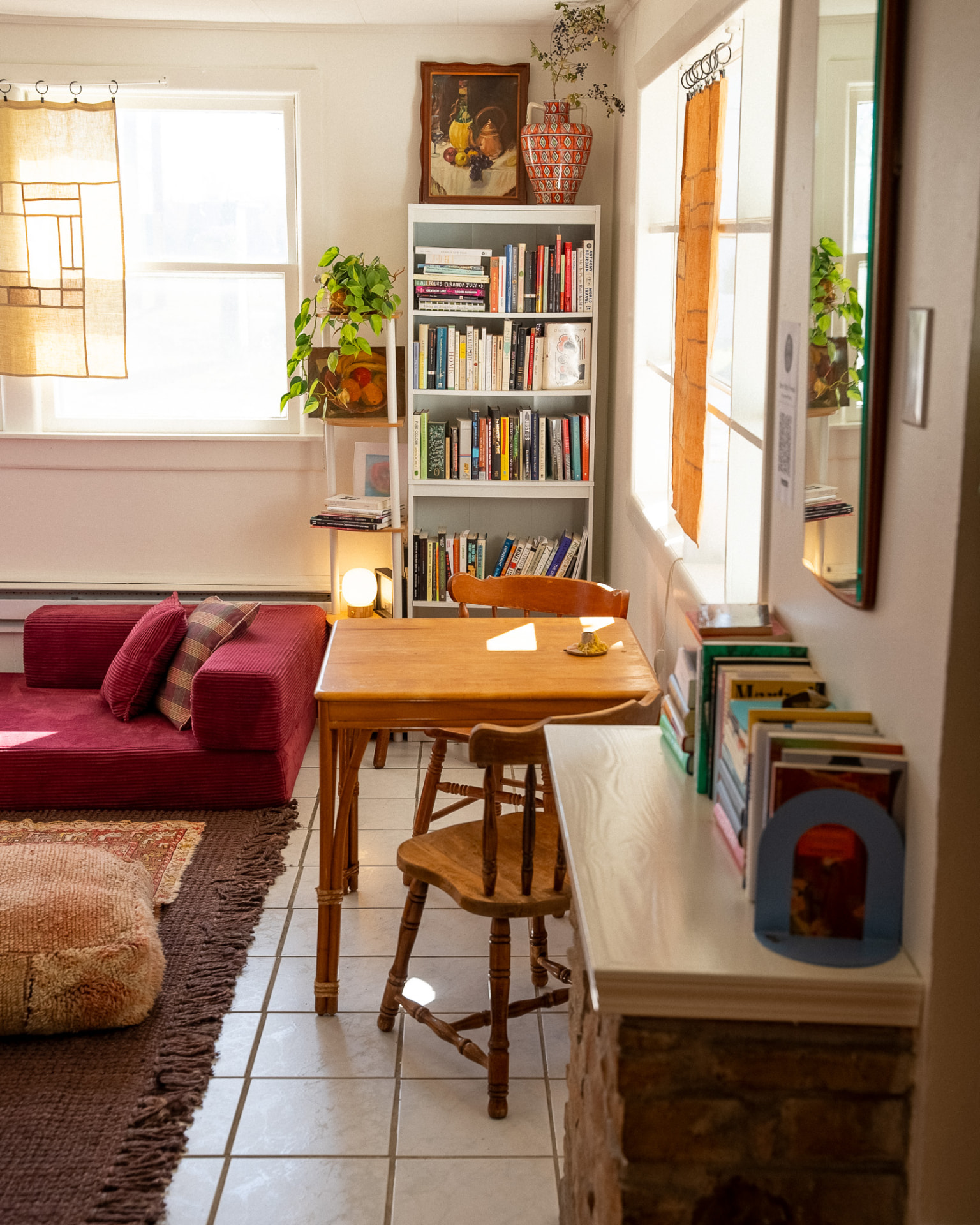 Breakfast nook beside a bookshelf and sunny window