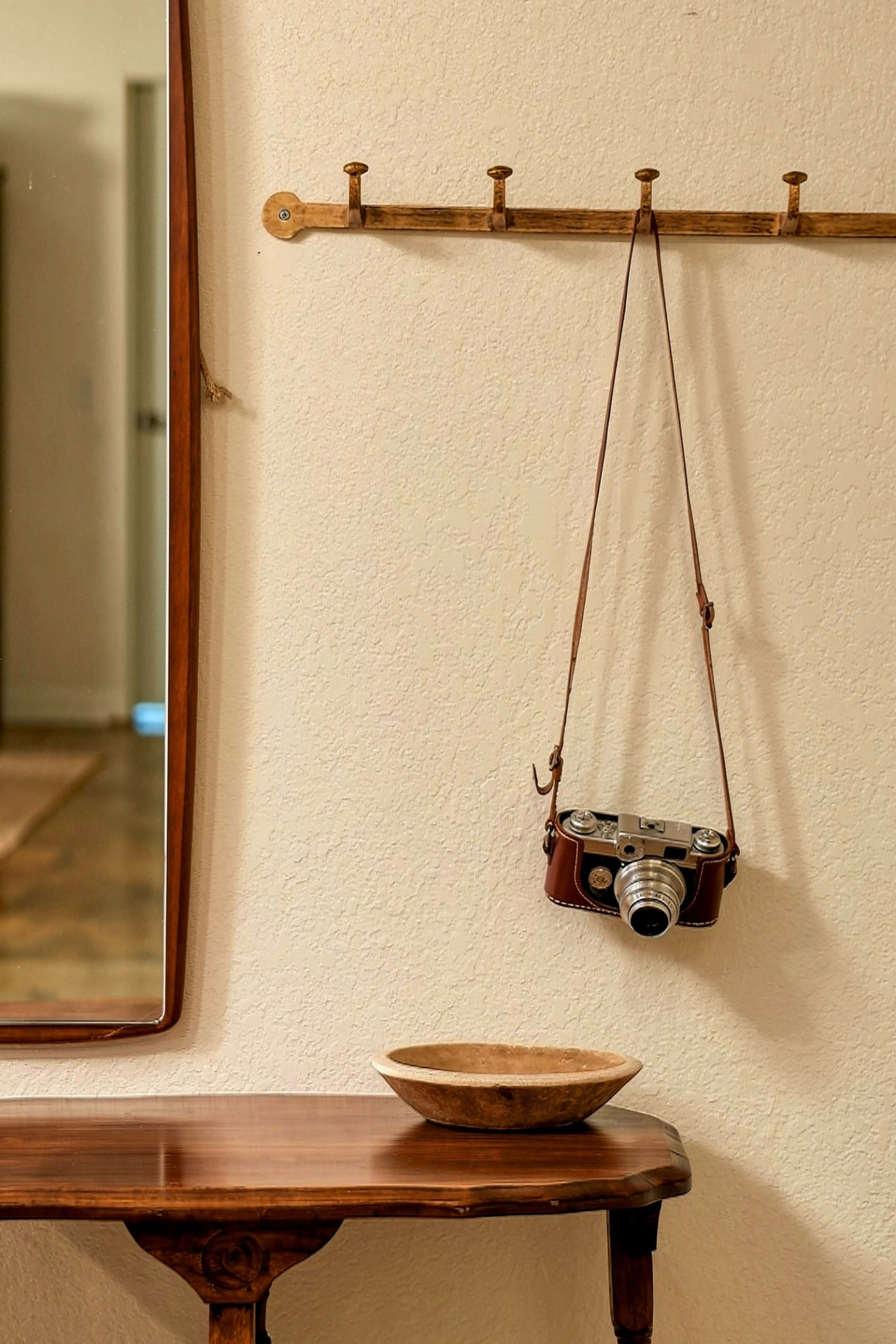 Vintage film camera hanging on a wall hook